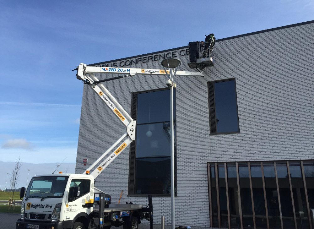 Installation team installing raised letter signage